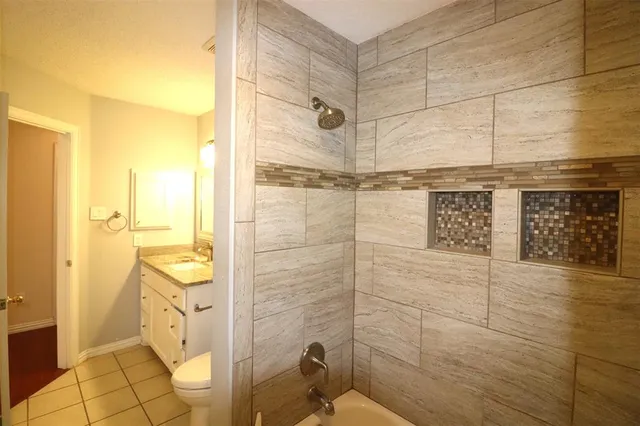 a bathroom with a shower and a sink