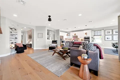 a living room with furniture and wooden floor