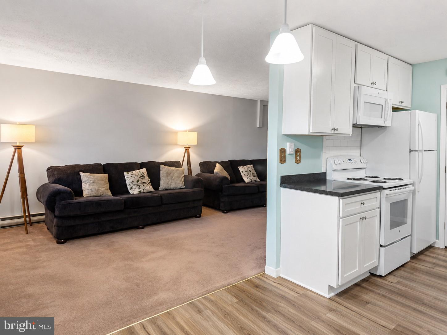 1724 Mosser Road, Unit 11 McHenry, MD 21541 - Photo 5 of 24 a kitchen with a refrigerator and a chandelier