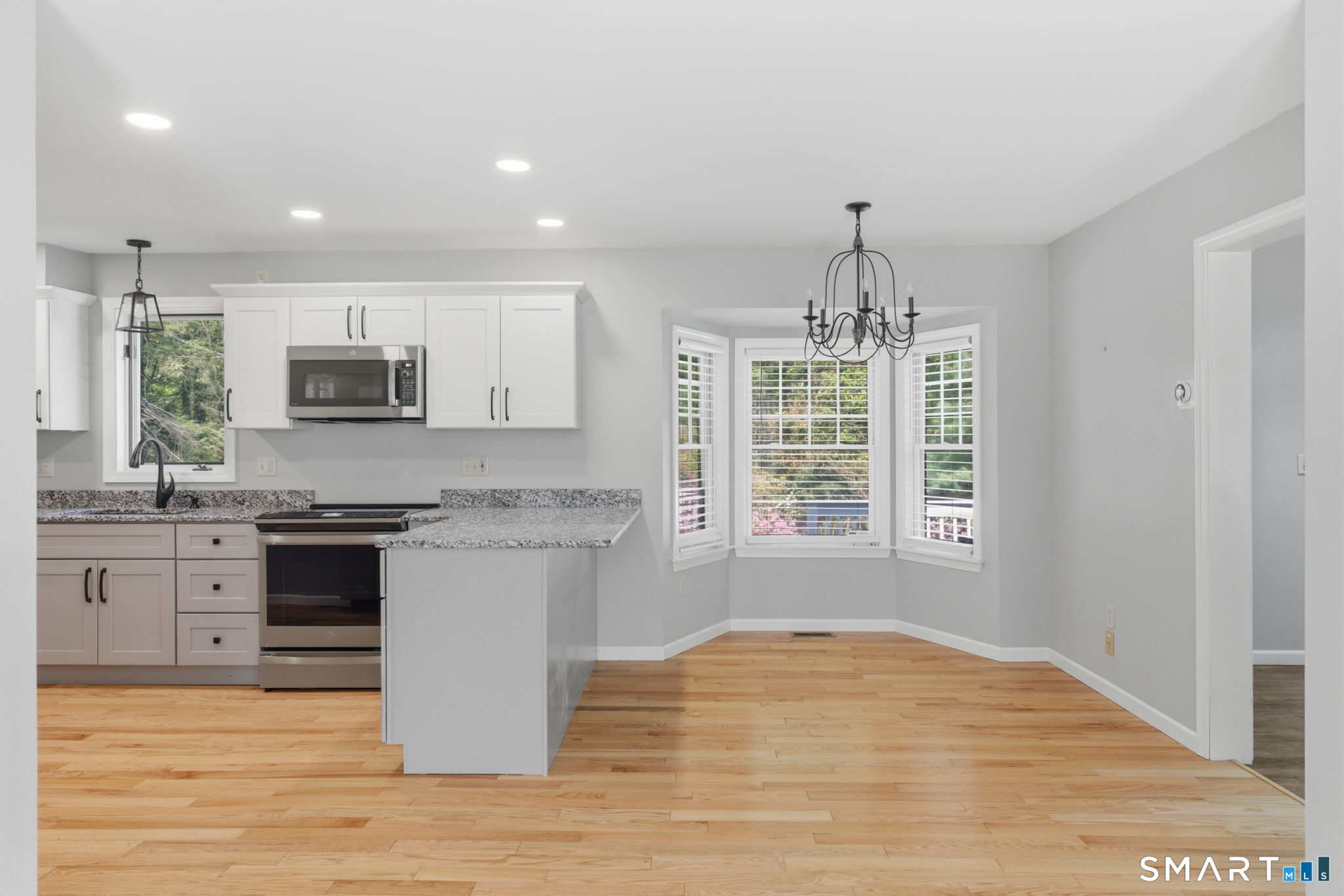 21 Greenwood Road North Granby, CT 06060 - Photo 11 of 40 a kitchen with stainless steel appliances granite countertop a stove top oven a sink dishwasher and a flat screen tv