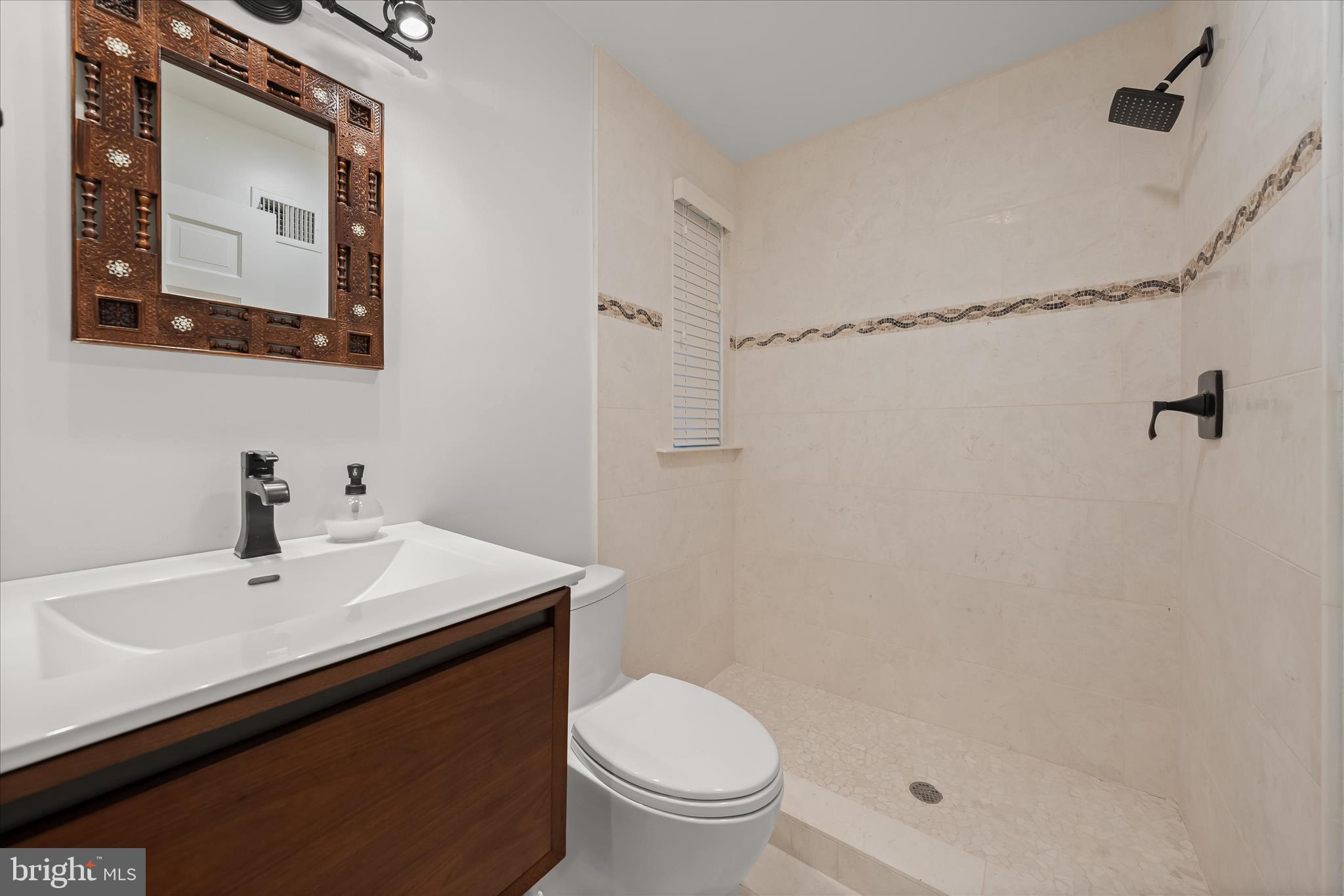5104 Scarsdale Road Bethesda, MD 20816 - Photo 6 of 68 a bathroom with a sink a toilet and shower