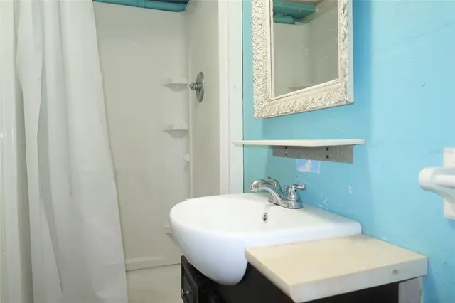 a bathroom with a sink and a mirror