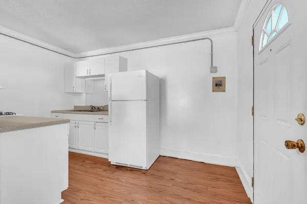 a kitchen with a sink stove and cabinets