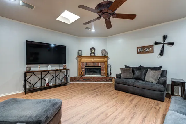 a kitchen with stainless steel appliances granite countertop a stove top oven a sink dishwasher a dining table and chairs with wooden floor