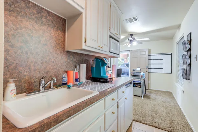 a view of a patio with table and chairs under an umbrella