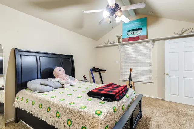 an aerial view of a house with a yard and ocean view
