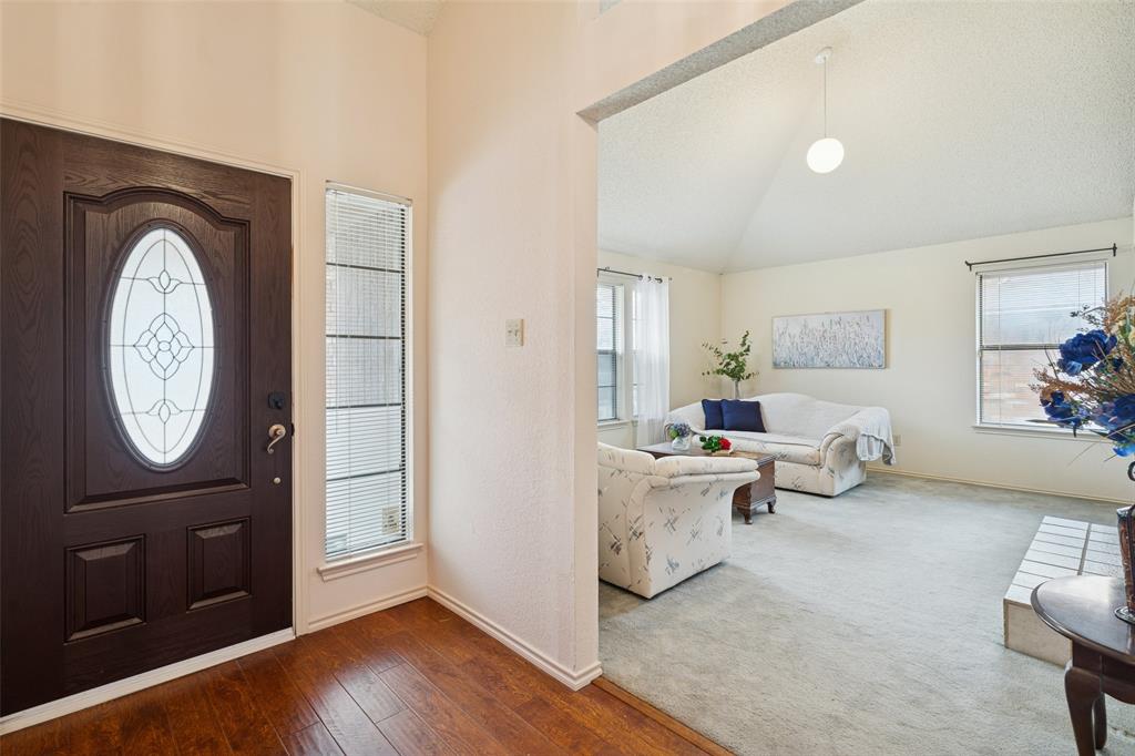 a living room with furniture a clock on wall and a mirror