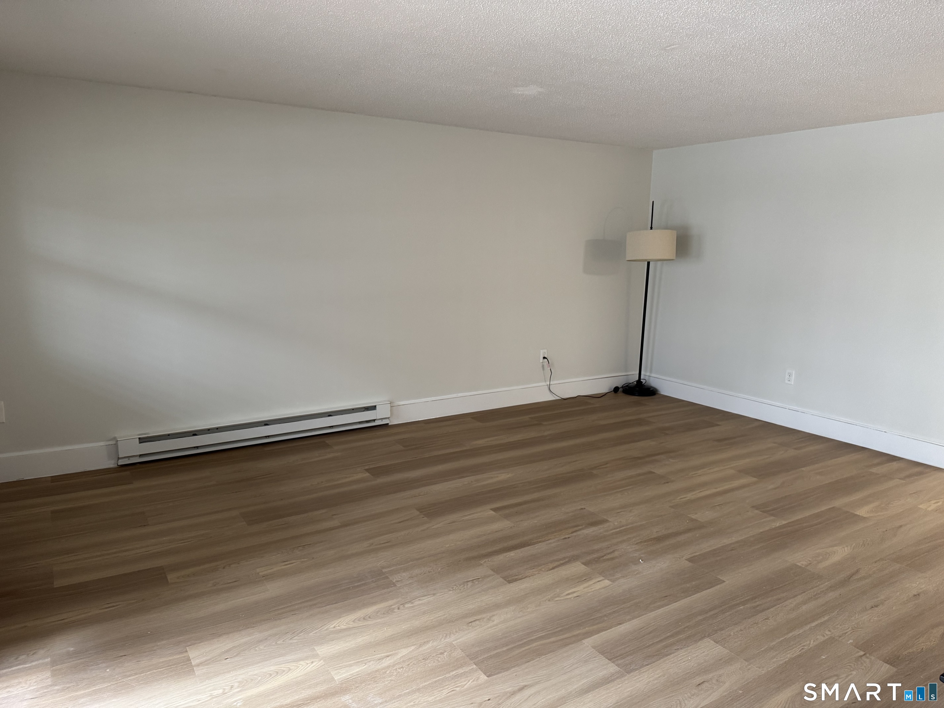 8 Heather Ridge, Unit 8 Shelton, CT 06484 - Photo 2 of 13 a view of an empty room with wooden floor