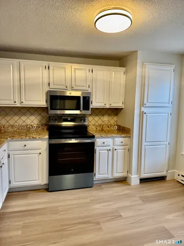 a kitchen with granite countertop a stove and a sink