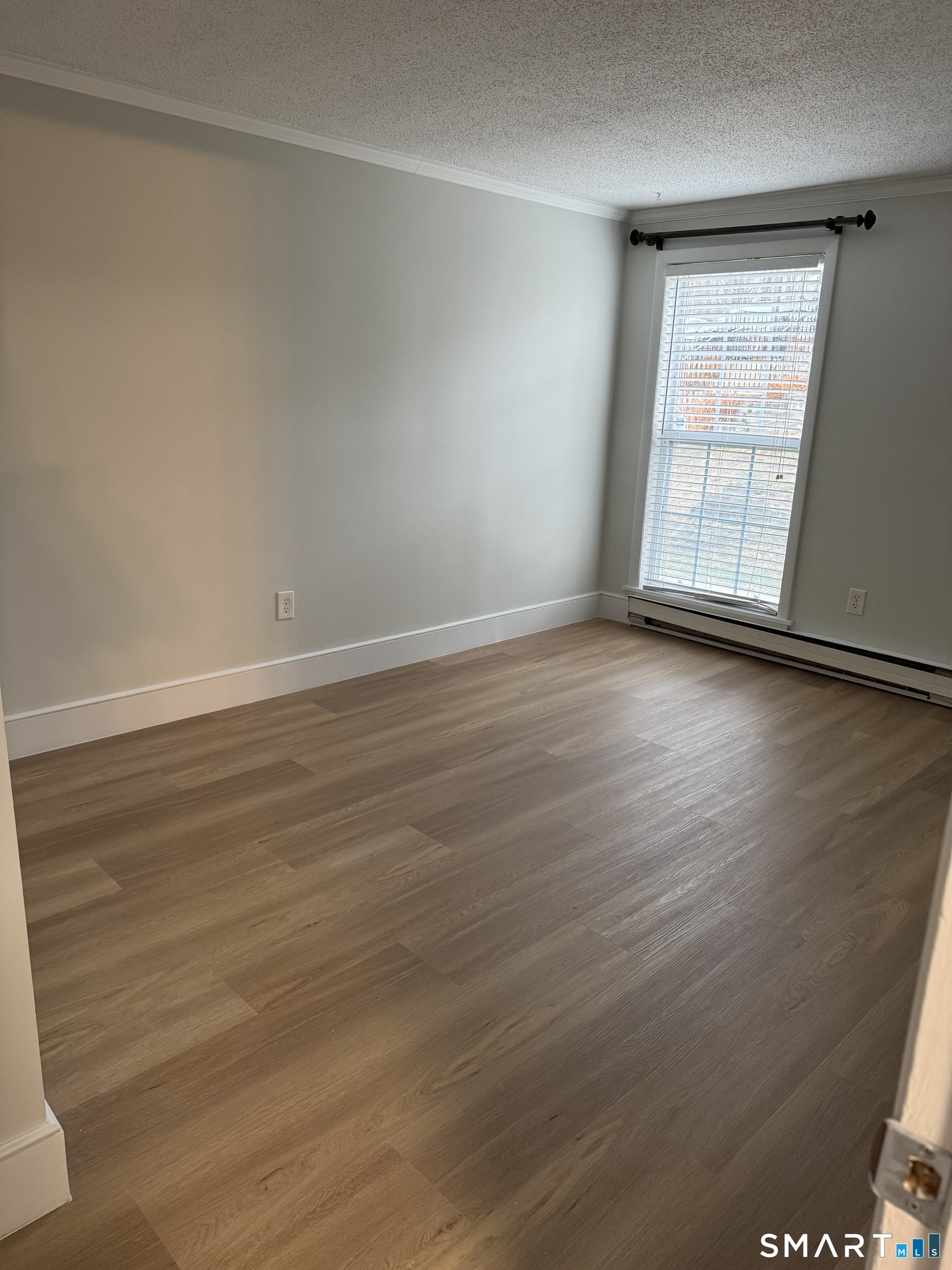 8 Heather Ridge, Unit 8 Shelton, CT 06484 - Photo 5 of 13 a view of an empty room with wooden floor and a window