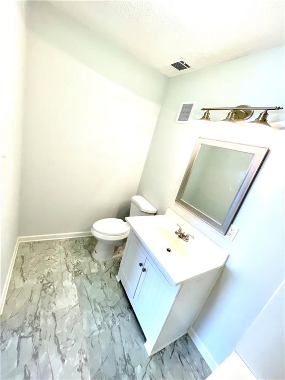 4701 Flat Shoals Road, Unit 68D Union City, GA 30291 - Photo 11 of 14 a bathroom with a toilet sink and mirror