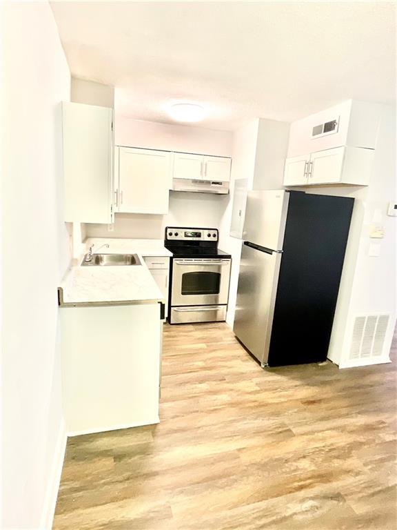 4701 Flat Shoals Road, Unit 68D Union City, GA 30291 - Photo 5 of 14 a kitchen with a sink stove and refrigerator