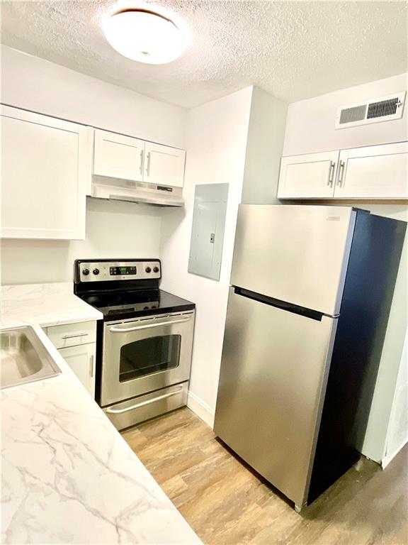 4701 Flat Shoals Road, Unit 68D Union City, GA 30291 - Photo 6 of 14 a kitchen with a refrigerator and a stove