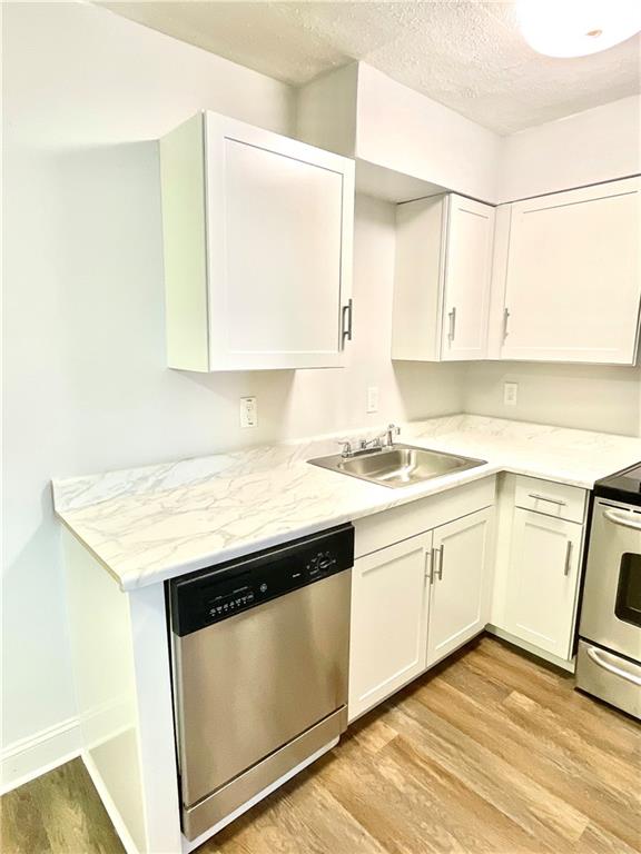 4701 Flat Shoals Road, Unit 68D Union City, GA 30291 - Photo 7 of 14 a kitchen with granite countertop a sink and cabinets