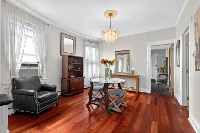 a living room with furniture dining table and a large window