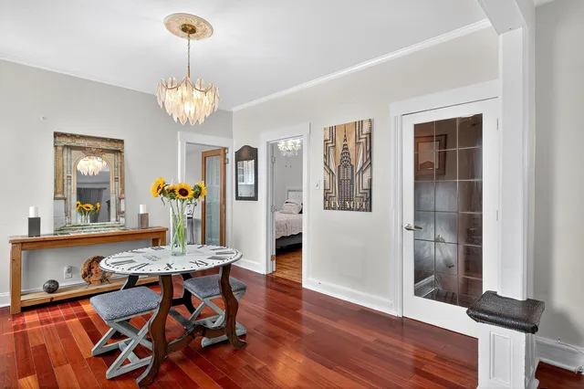 a view of a dining room with furniture and chandelier