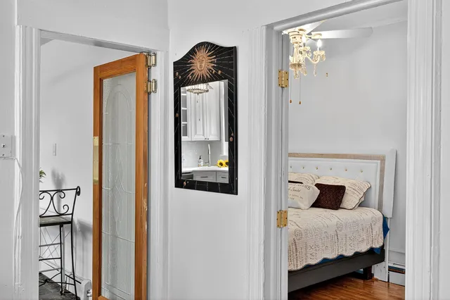 a bedroom with a bed and a mirror