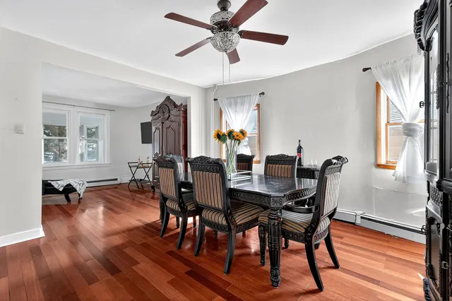 a view of a dining room with furniture window and wooden floor
