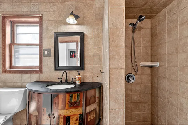 a bathroom with a toilet a sink and a mirror