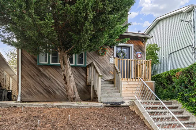a view of a house with wooden fence