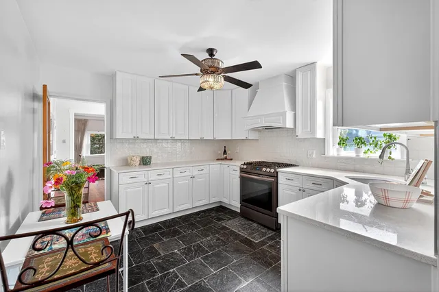 a kitchen with a sink stove and cabinets