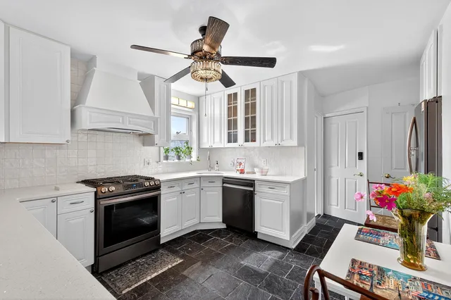 a kitchen with stainless steel appliances granite countertop a stove a sink and a refrigerator