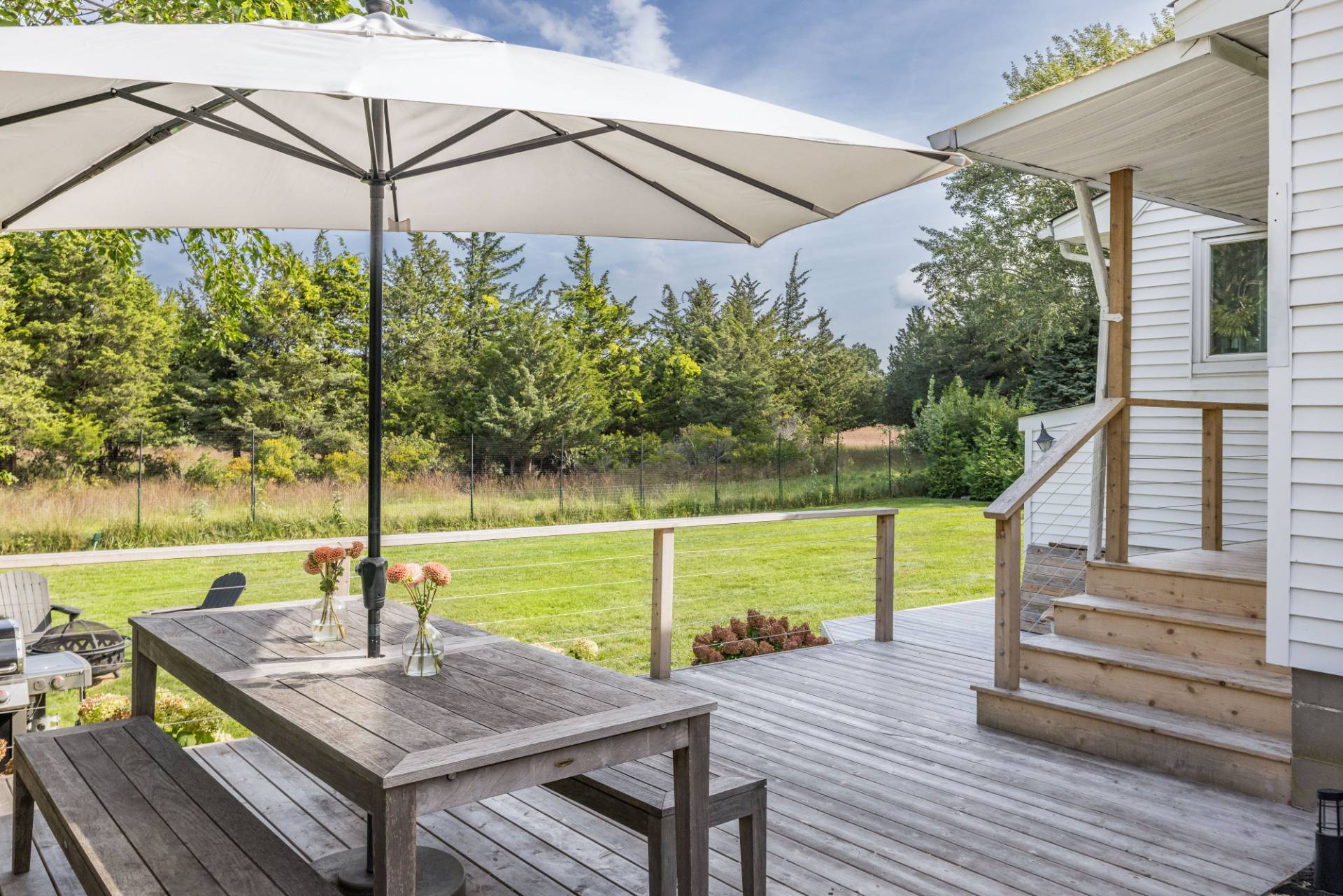 21 Thistle Patch Lane Sag Harbor, NY 11963 - Photo 13 of 17 a view of a roof deck with wooden floor and fence