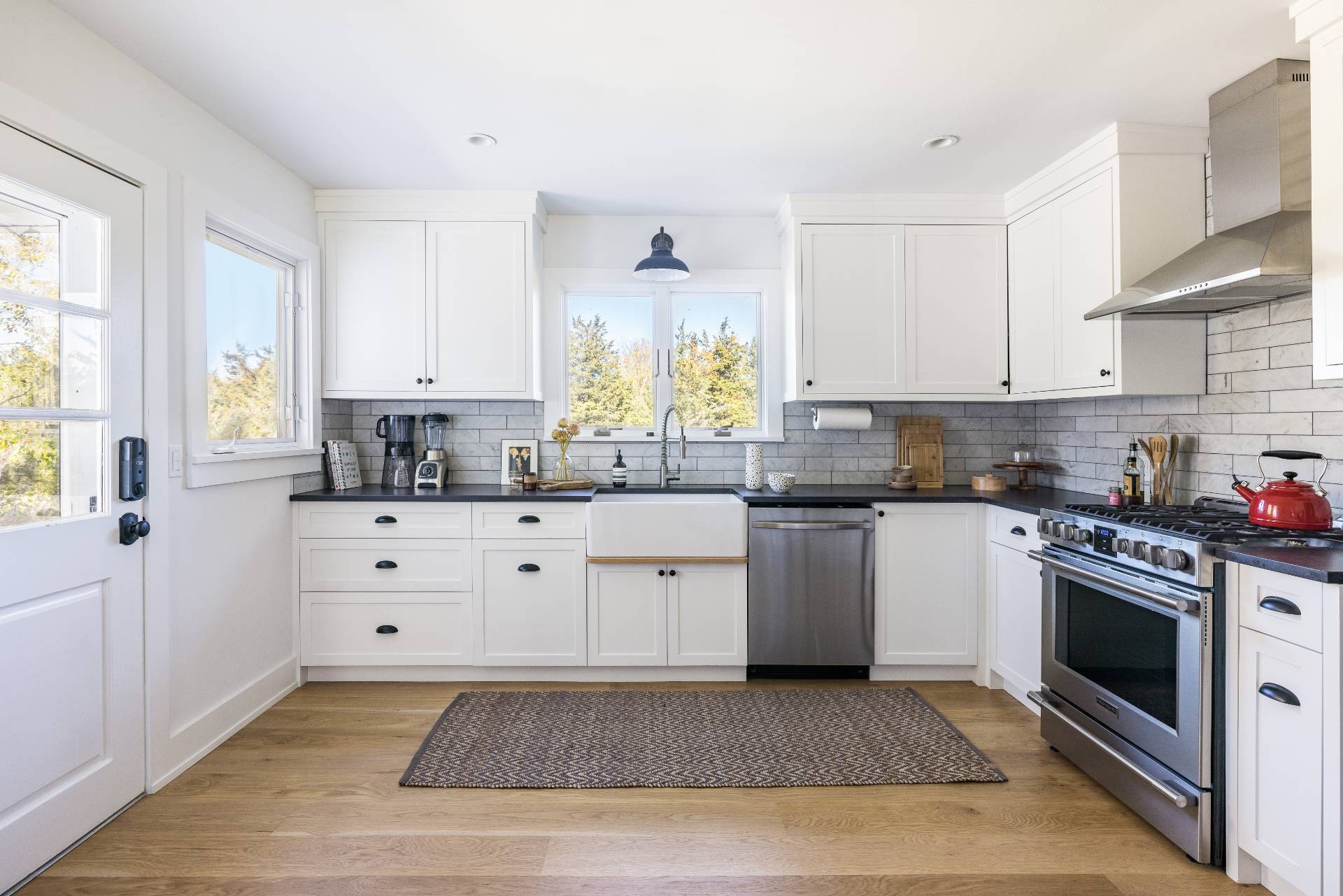 21 Thistle Patch Lane Sag Harbor, NY 11963 - Photo 3 of 17 a kitchen with granite countertop white cabinets stainless steel appliances a sink and a window