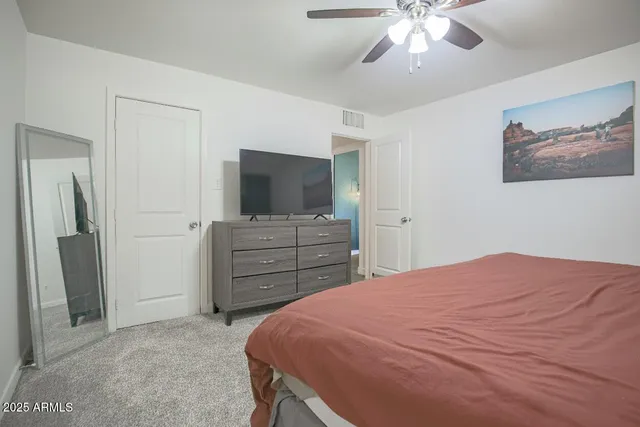 a bedroom with a bed and a flat screen tv
