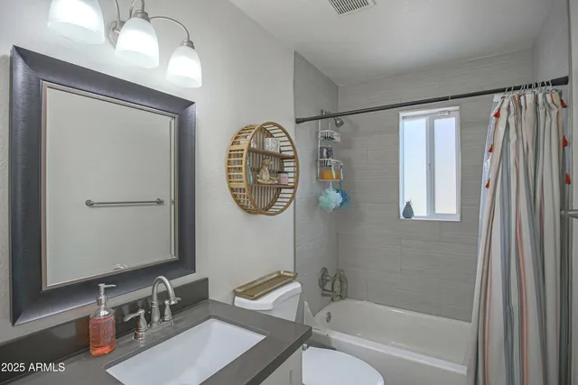 a bathroom with a bathtub a shower a toilet and a sink