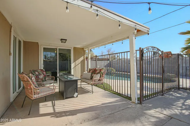 a view of a patio with a table and chairs