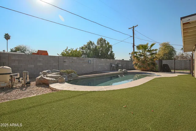 a view of a swimming pool with a yard