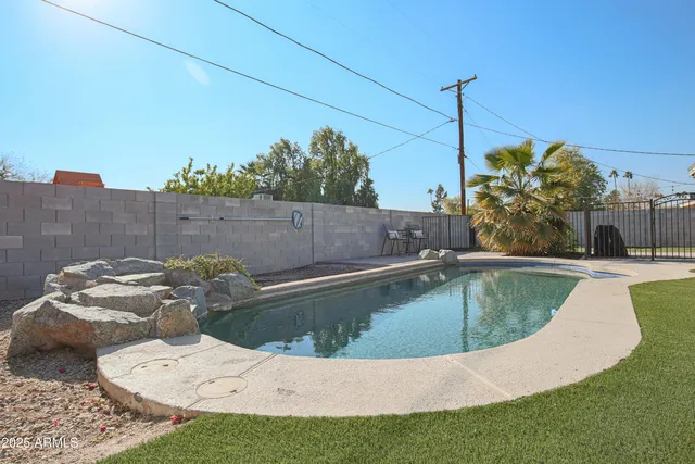 a view of a swimming pool with a yard
