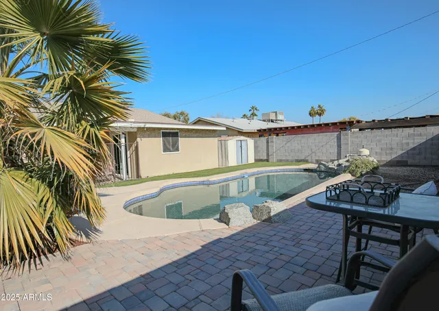 a view of a house with backyard and sitting area