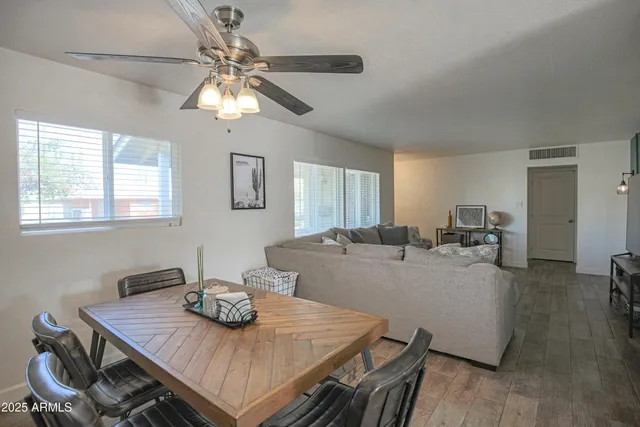 a view of a dining room with furniture a chandelier and wooden floor