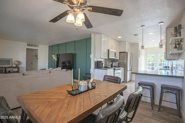 a view of a dining room with furniture and wooden floor