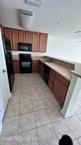 a kitchen with stainless steel appliances a sink and a counter top space