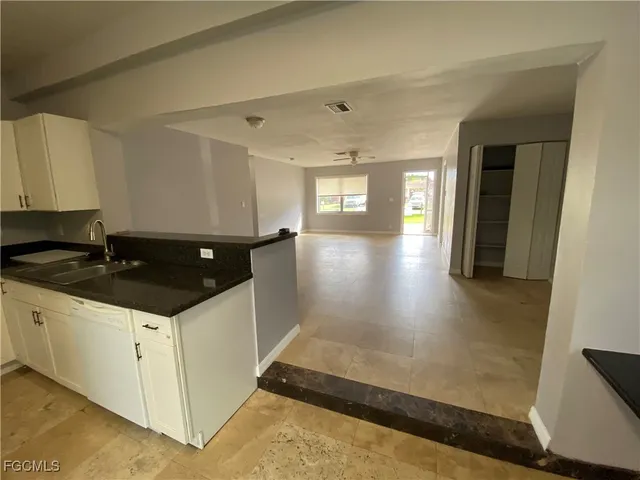 a kitchen with sink and cabinets