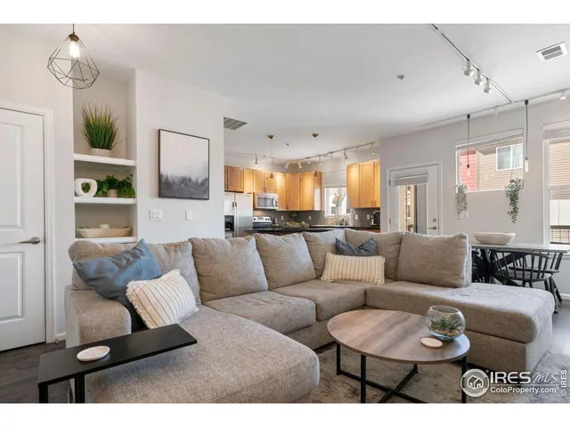 a living room with furniture and a painting