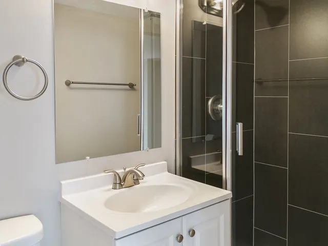 a bathroom with a sink toilet and shower