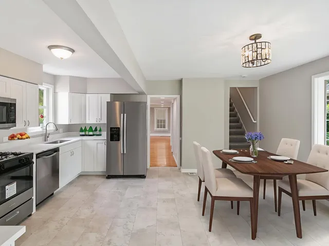 a kitchen with a refrigerator and a table