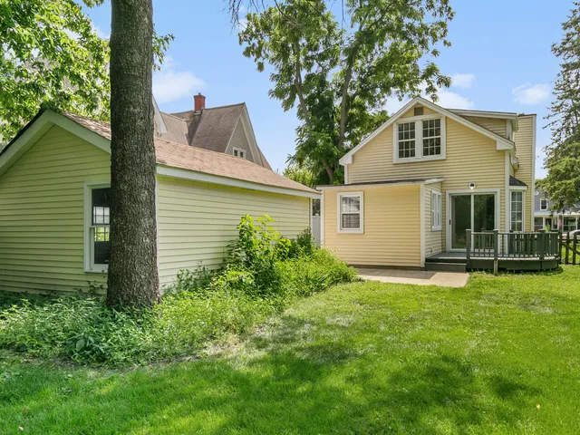 a view of a house with a yard and sitting area