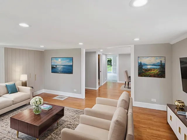 a living room with furniture and wooden floor