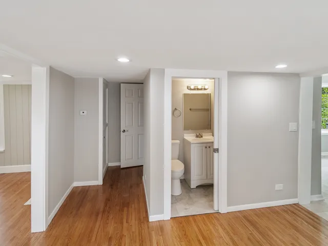 a view of a hallway with wooden floor