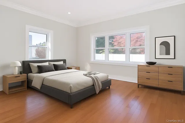 a bedroom with bed and window with wooden floor