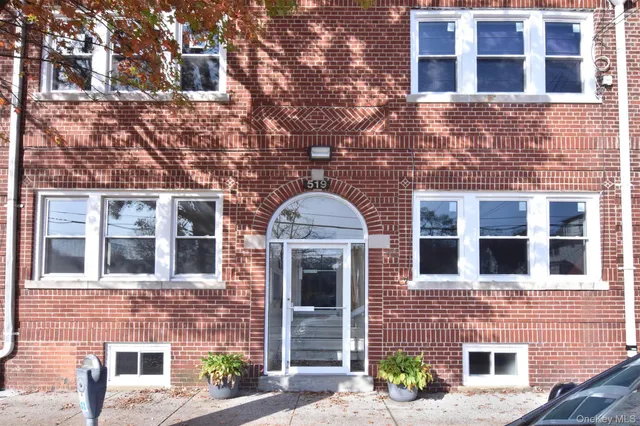 a view of a brick building with many windows