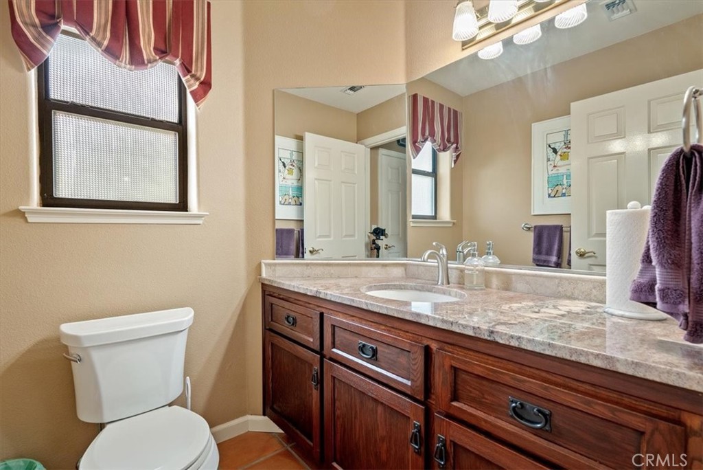2955 San Fernando Road Atascadero, CA 93422 - Photo 21 of 62 a bathroom with a granite countertop toilet sink and mirror