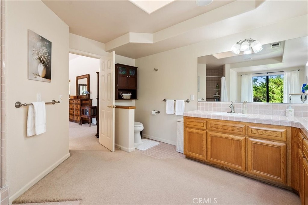 2955 San Fernando Road Atascadero, CA 93422 - Photo 29 of 62 a spacious bathroom with a double vanity sink a mirror a bathtub and a shower