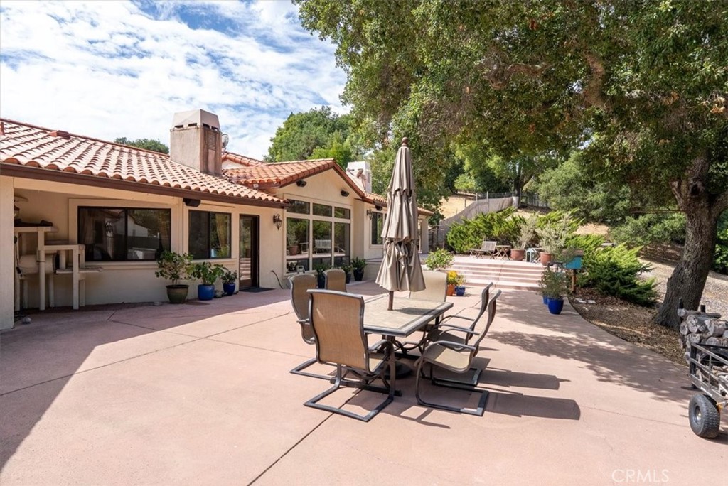 2955 San Fernando Road Atascadero, CA 93422 - Photo 38 of 62 a view of a patio with table and chairs and floor to ceiling window
