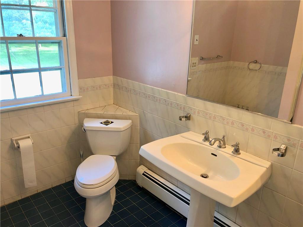 236 Creek Road Poughkeepsie, NY 12601 - Photo 11 of 18 Bathroom with tile walls, tasteful backsplash, toilet, and tile patterned flooring